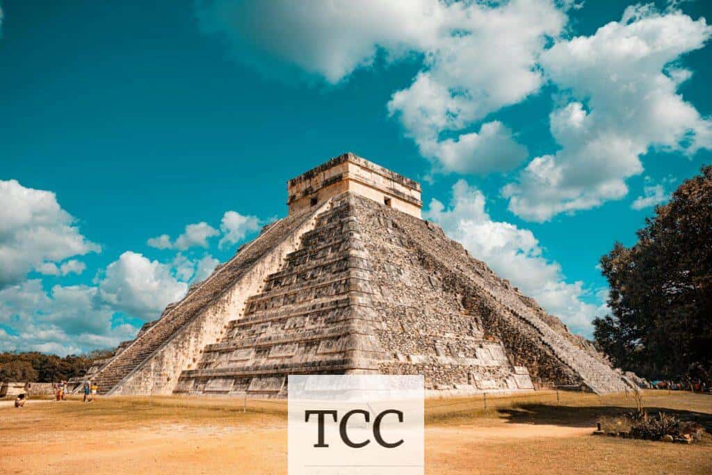 The iconic El Castillo pyramid at Chichen Itza, Mexico, captured on a sunny day with a vibrant blue sky.