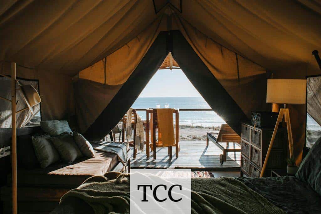 A luxurious tent setup with a view of the ocean, perfect for a peaceful getaway.